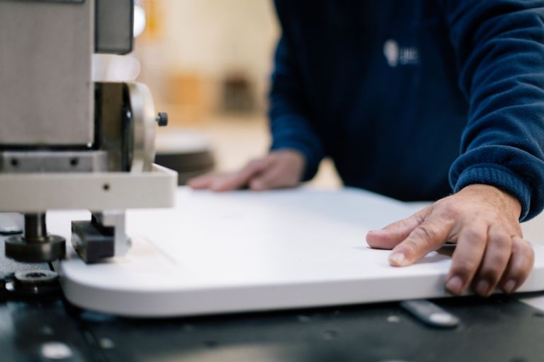 Close-up of a&nbsp;craftsman using machinery for precision woodwork indoors.